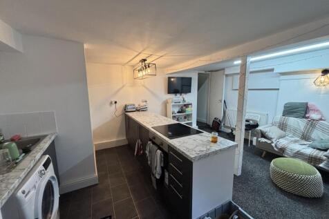 A bright and modern living room featuring comfo...