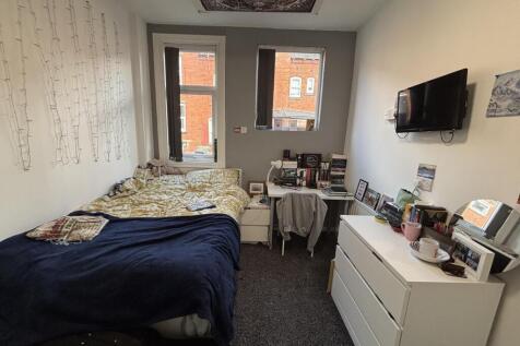 A cozy bedroom with a comfortable double bed, a...