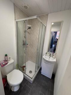 A clean and modern bathroom featuring a shower ...