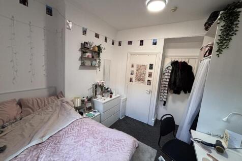 A cozy and well-maintained bedroom featuring a ...