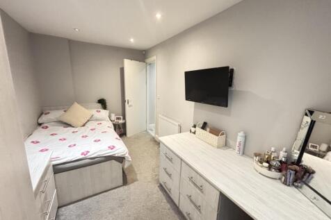 A well-maintained bedroom featuring a comfortab...