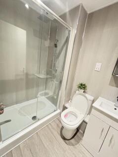 Modern bathroom featuring a spacious shower wit...