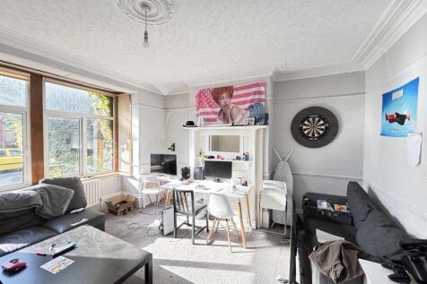 Bright and welcoming living room with large win...