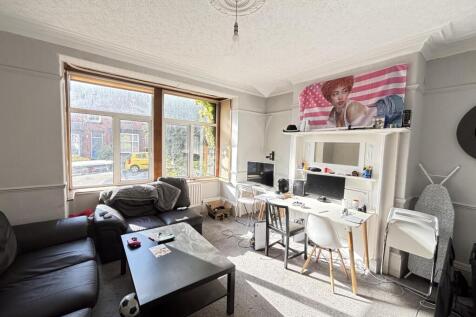 A bright and spacious living room featuring lar...