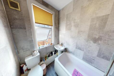 Bright and clean bathroom suite featuring a spa...