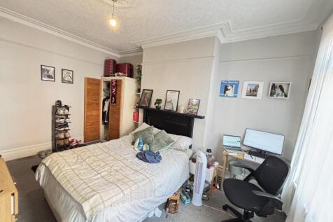 Bright and spacious master bedroom featuring a ...