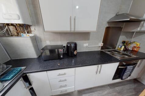 A modern kitchen with sleek countertops and amp...