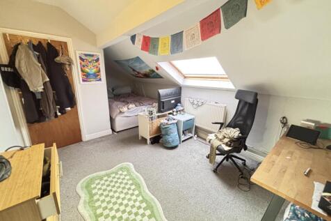 A bright and welcoming living room featuring a ...