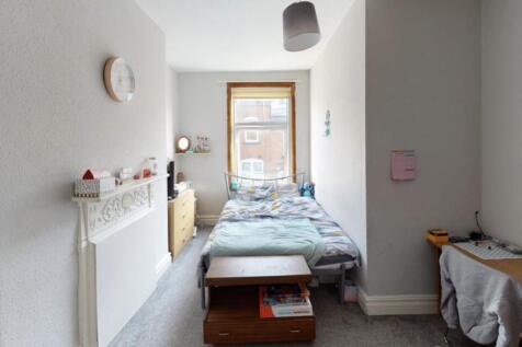 A cozy bedroom with a double bed, featuring nat...