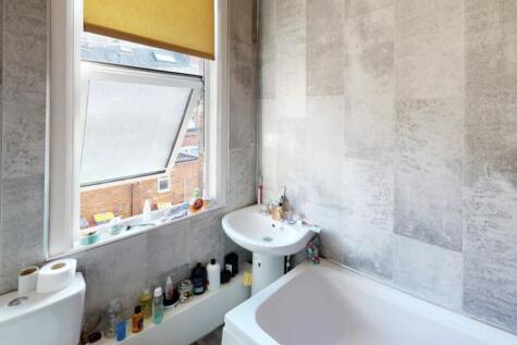 A well-maintained bathroom with a large window ...