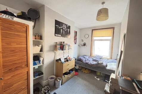 A cozy bedroom with a window providing natural ...