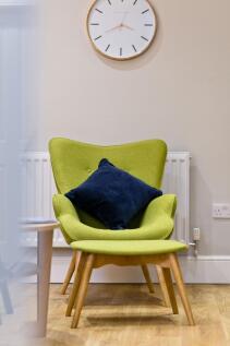 Bright, stylish seating corner with a modern gr...
