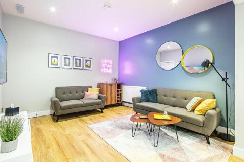 Bright and stylish living room featuring modern...