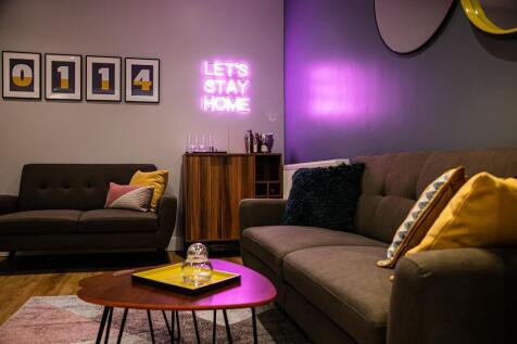 A modern, cozy living room featuring comfortabl...