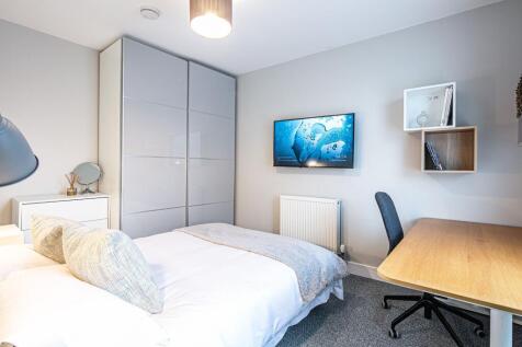 Bright and modern bedroom featuring a cozy bed ...