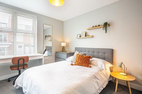Bright and modern double bedroom featuring a la...