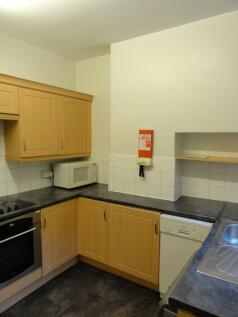 A well-maintained kitchen featuring wooden cabi...