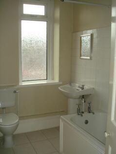 A functional bathroom with a small bathtub, a s...