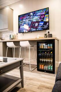 Contemporary living room featuring a large wall...