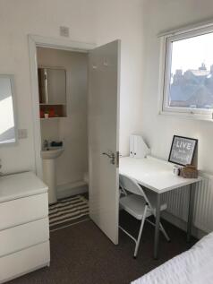 Bright, tidy bedroom with a study corner by a l...