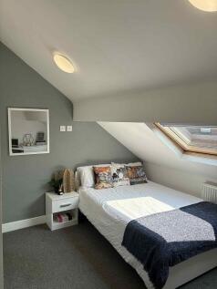 Bright, neatly styled double bedroom in a loft ...