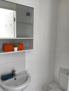 Bright, simple bathroom with a clean white sink...