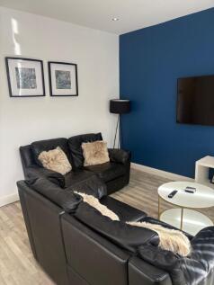 Modern living room with matching black leather ...