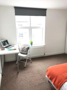 Bright, well-presented bedroom with a large win...