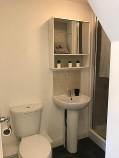 Neat compact bathroom with a pedestal sink, WC ...