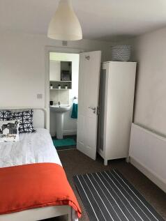 Bright, neatly presented bedroom with a comfort...