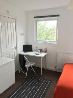 Bright, tidy single bedroom with a study desk b...