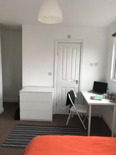 Bright, neatly presented bedroom with a simple ...