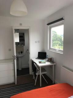 Bright, neatly presented bedroom with a practic...