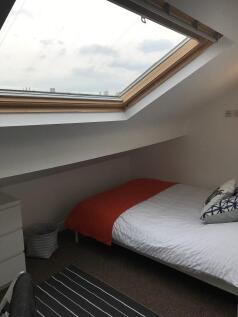 Bright attic bedroom with a large skylight, nea...