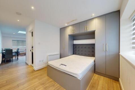 Bright, modern bedroom with integrated grey fit...