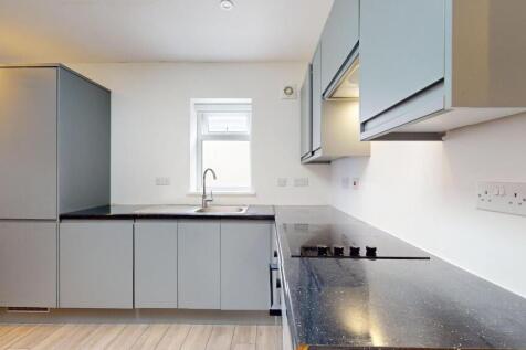 Modern fitted kitchen with sleek grey cabinetry...