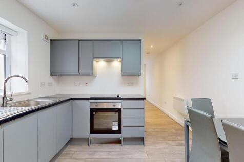 Bright modern kitchen with sleek grey cabinetry...