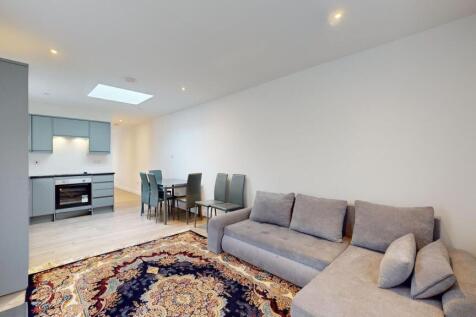 Bright open-plan living space with a large grey...