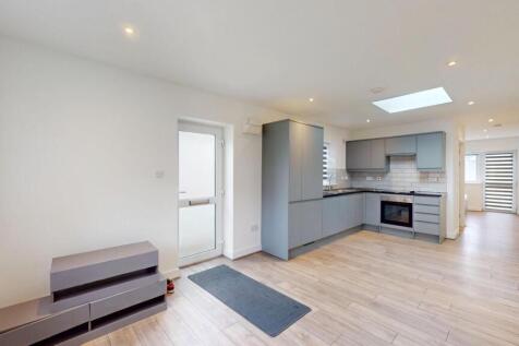 Bright, modern open-plan living area with a sle...