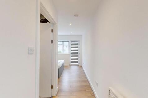 Bright, freshly painted hallway with wood-effec...