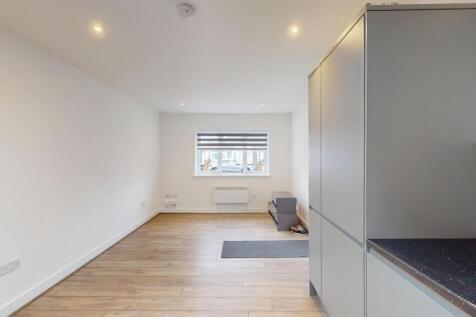 Bright, modern open-plan living area with reces...