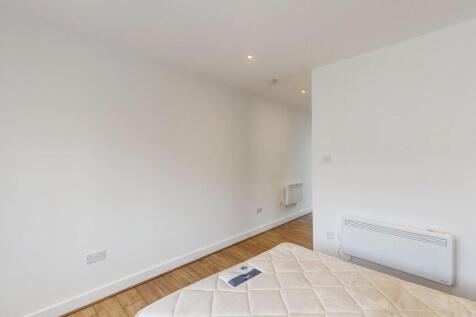 Bright, simply finished bedroom with wooden flo...