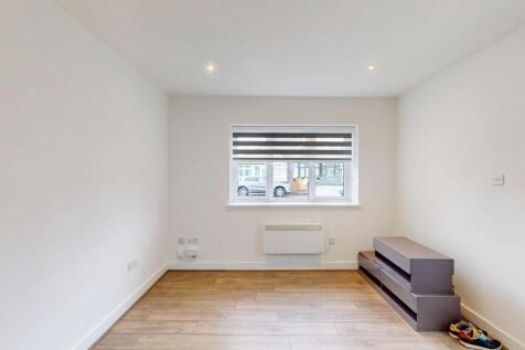 Bright, modern living area with wood-effect flo...