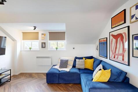 Bright, modern living room with a deep-blue cor...