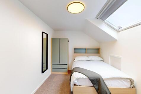 Bright, neatly presented bedroom with a comfort...