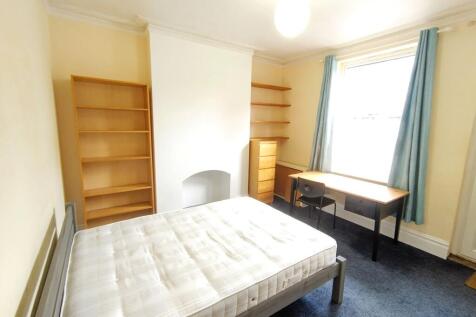 Bright furnished bedroom with a double bed, lar...