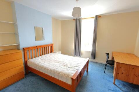 Bright, well-presented bedroom with a wooden do...