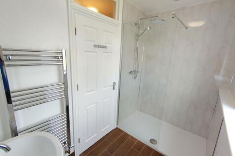 Bright, modern bathroom with a large walk-in sh...
