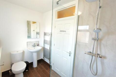 Bright, modern bathroom with a walk-in shower, ...