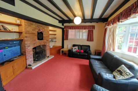 Spacious, cosy living room with exposed ceiling...